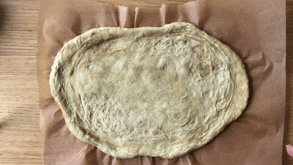 Kneading pizza dough in baking sheet