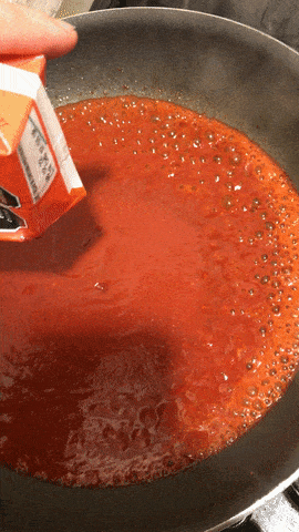 Pouring guajillo sauce