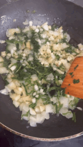Frying onion coriander chives in a small pan
