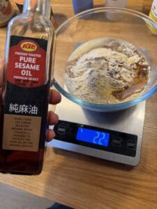 Sesame seed oil with a scale on the back