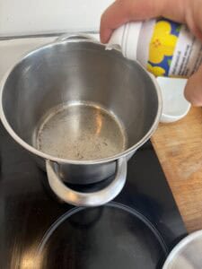 Spraying oil on pot